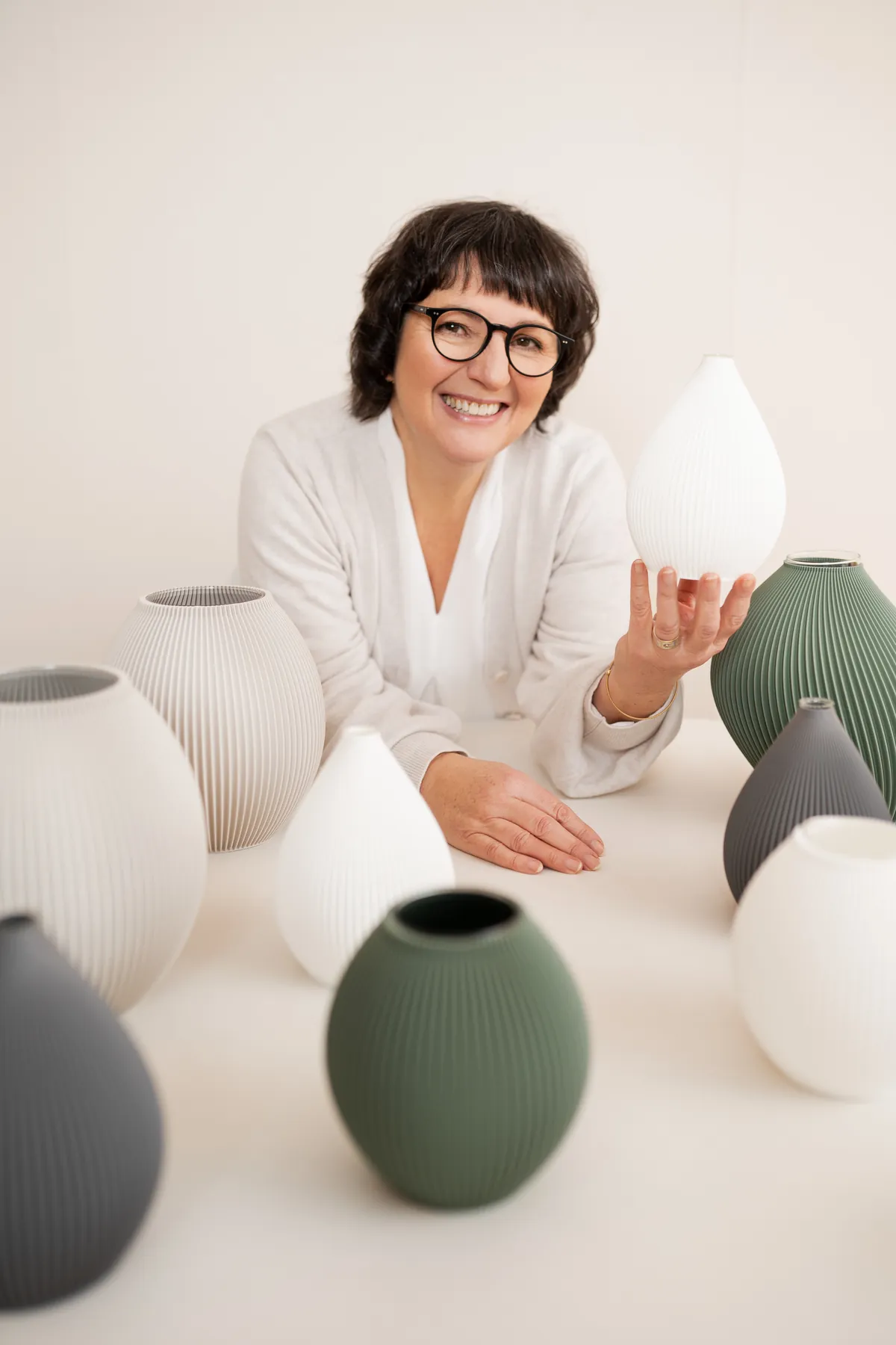 Patricia Grünenwald with vases made from recycled plastic
