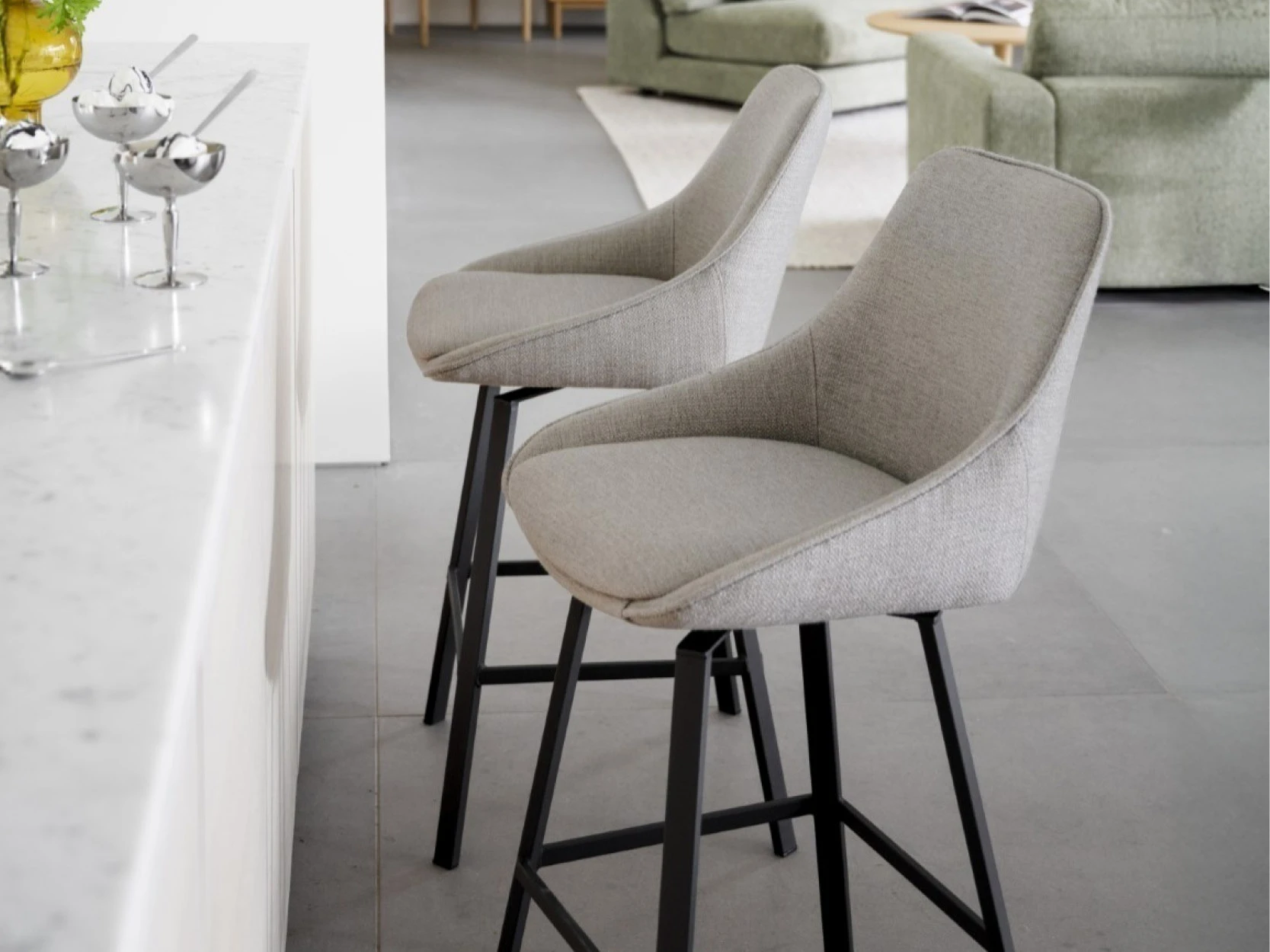 Bar stool with backrest and armrests at a kitchen counter