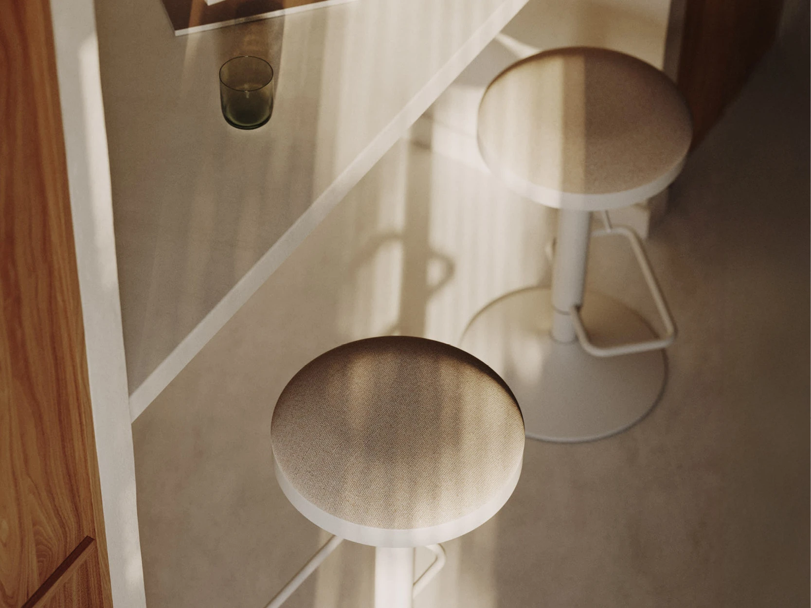 Bar stools at an open-plan kitchen island in a modern kitchen-diner